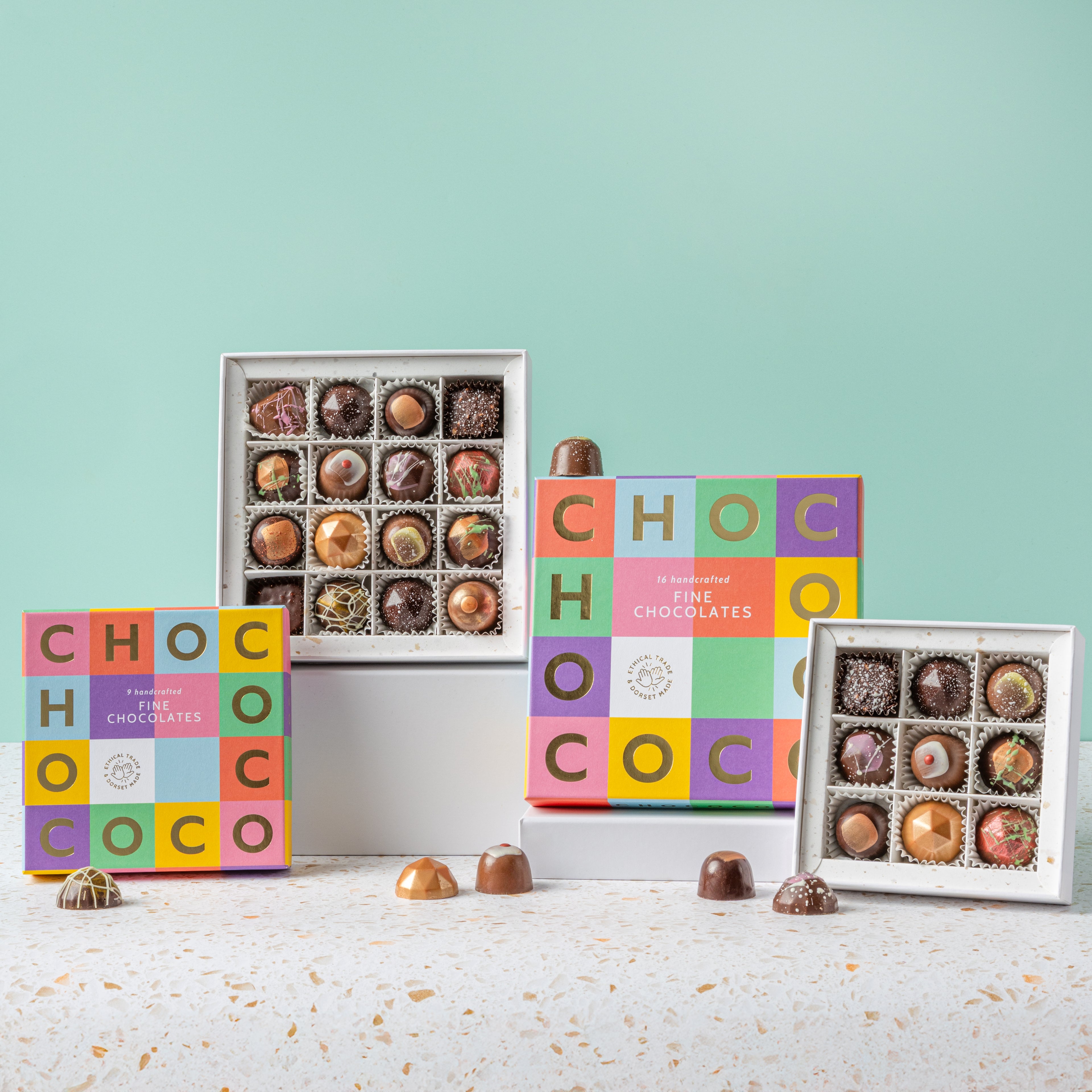Assorted chocolates in colorful boxes on a light blue background