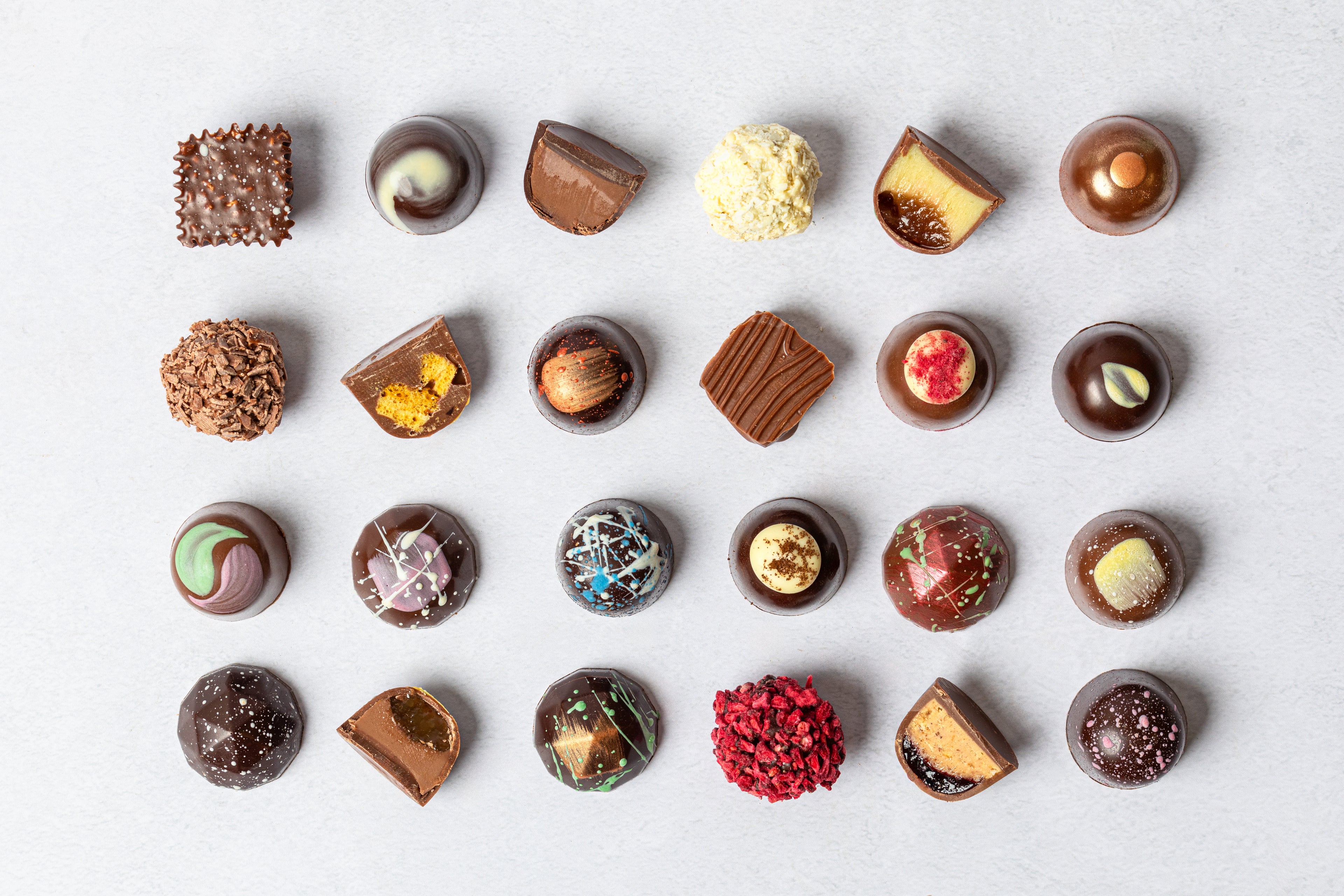 Assorted chocolates on a light gray background
